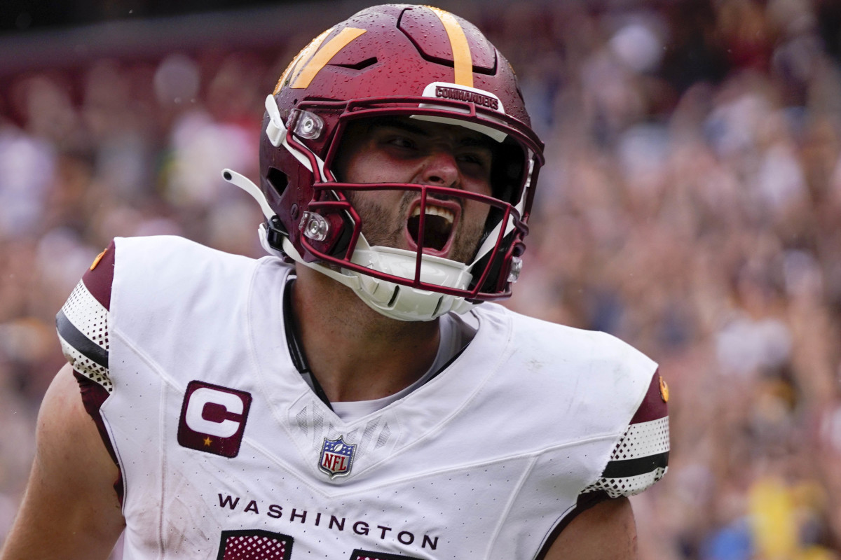 Sep 10, 2023; Landover, Maryland, USA; Washington Commanders quarterback Sam Howell (14) reacts after rushing for a touchdown against the Arizona Cardinals at FedExField. Mandatory Credit: Brent Skeen-USA TODAY Sports